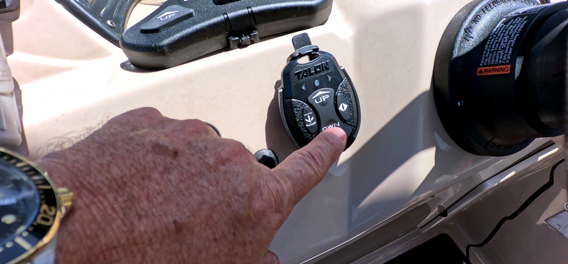 Minn Kota Talon wireless remote being used on a pontoon boat